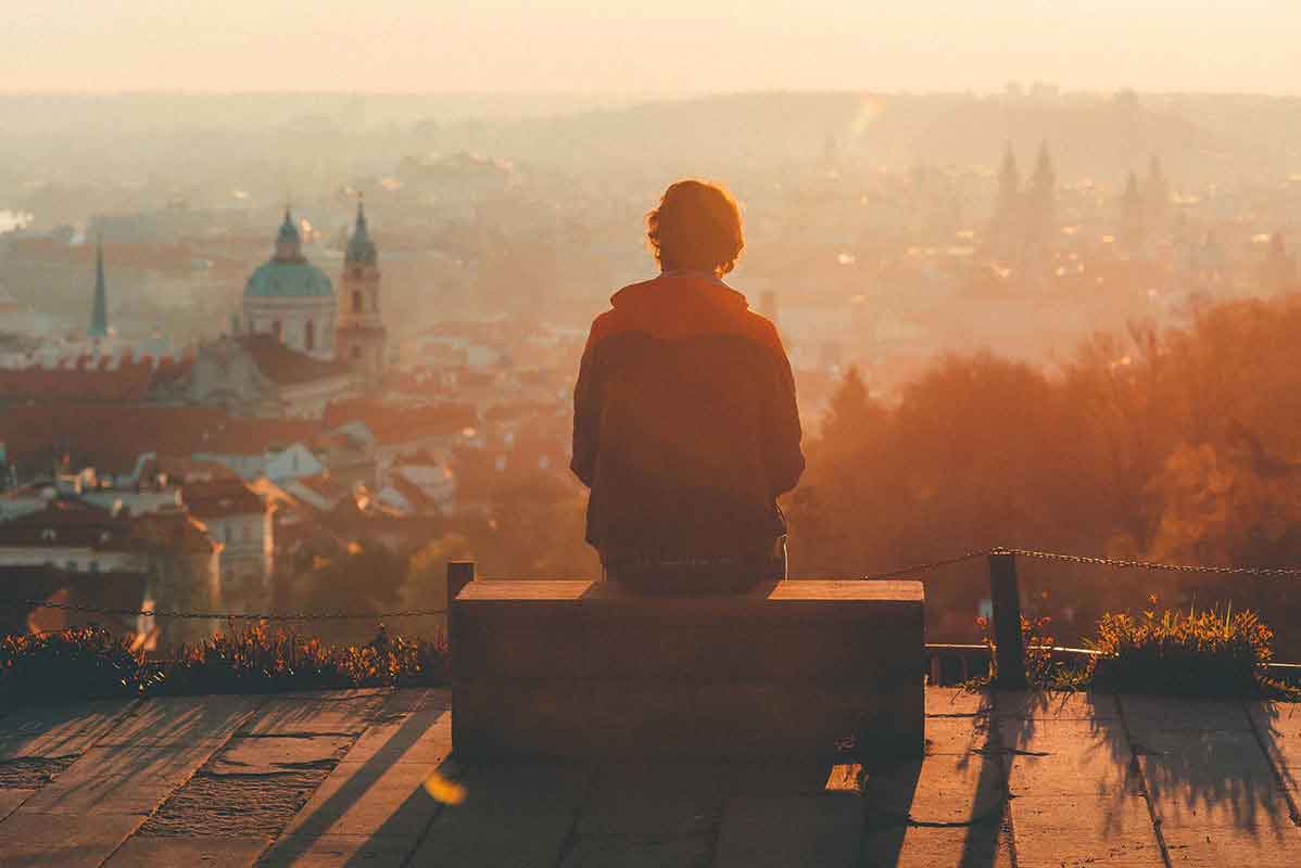 Man staring out at a landscape in a foreign country