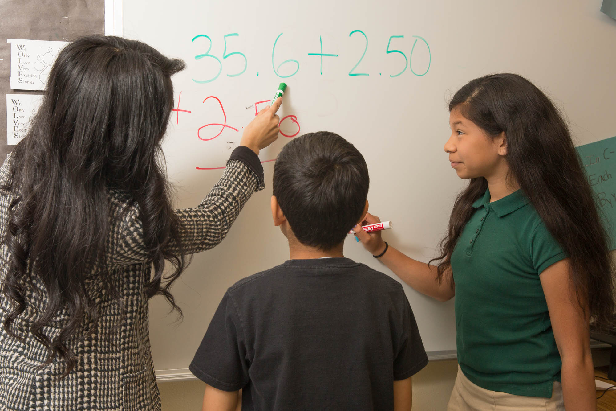 Student teacher working with two students