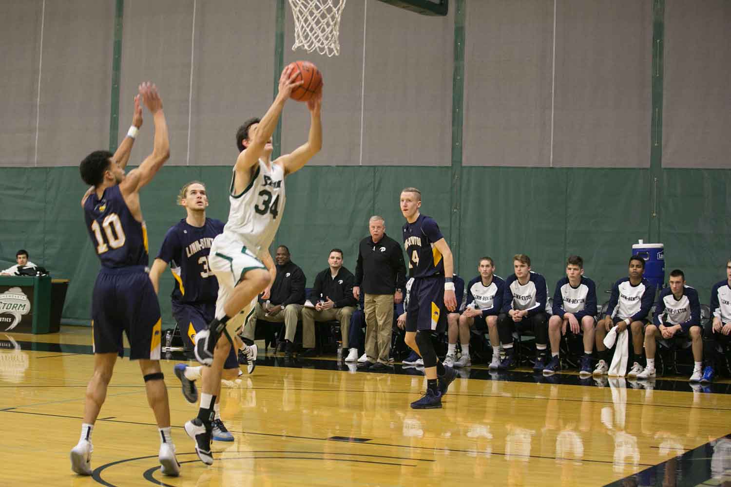 A men's basketball player jumps with the ball