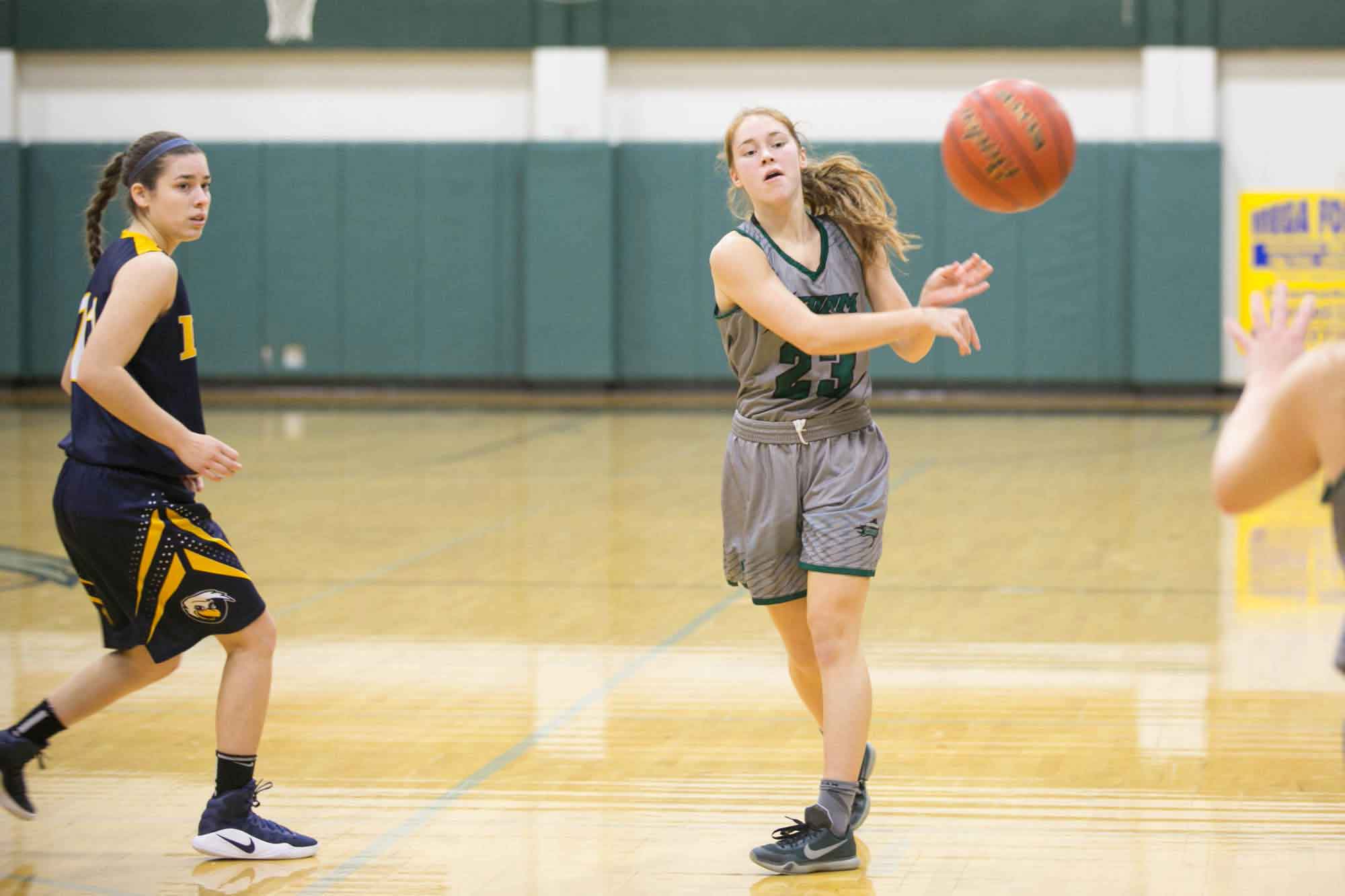 A Storm women's basketball player passes the ball