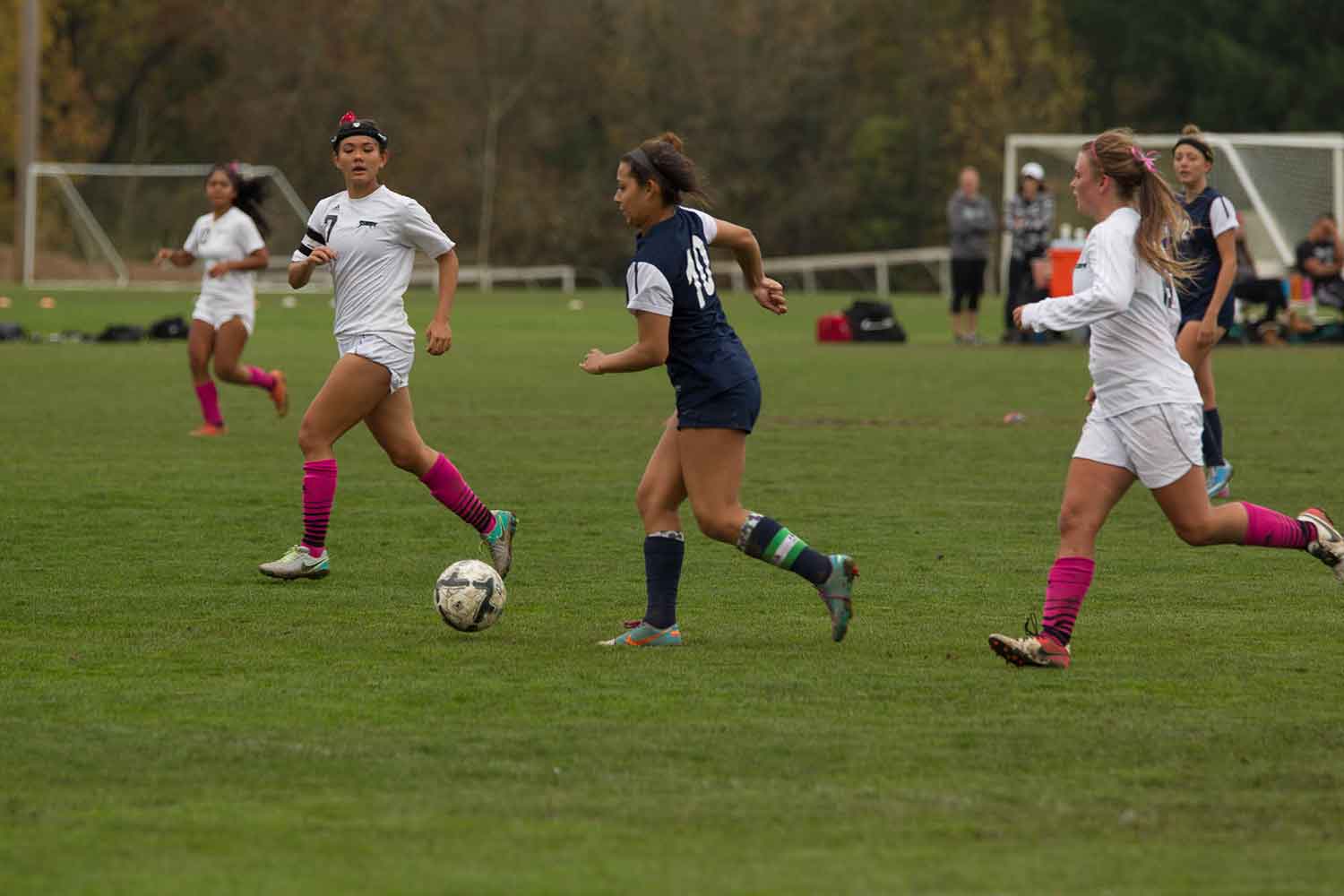 Women soccer players two against one