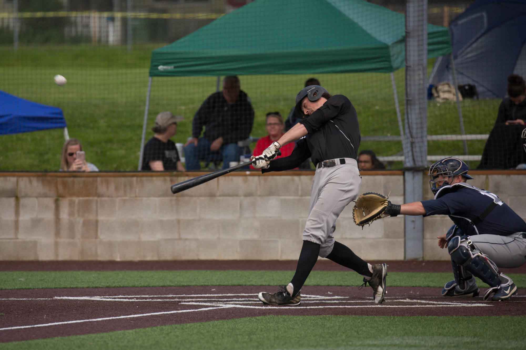 Baseball player hits a fly ball