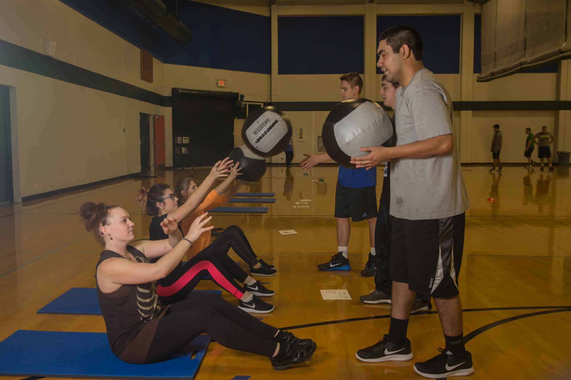 Students practicing with medicine balls