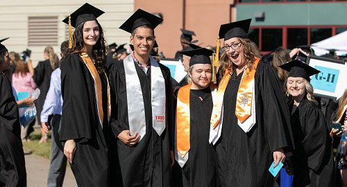 A group of TRIO students at commencement in full regalia