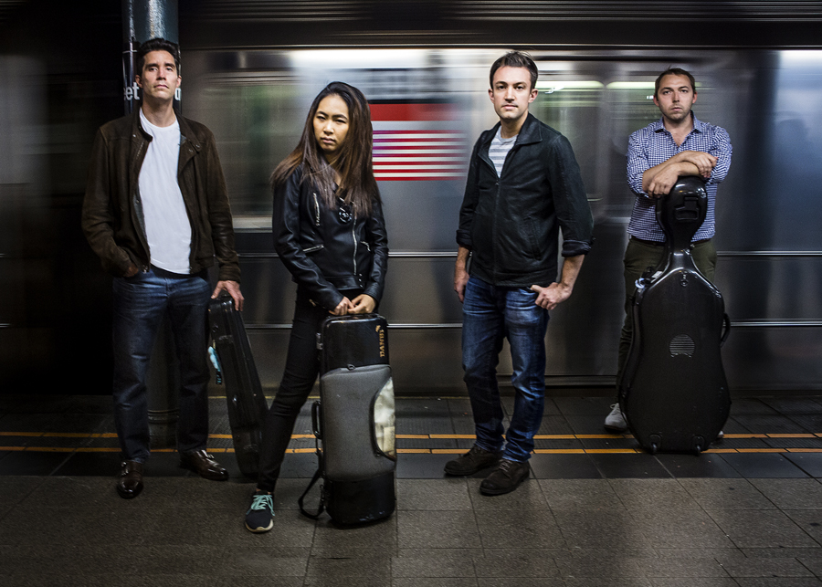 Escher String Quartet standing in the subway